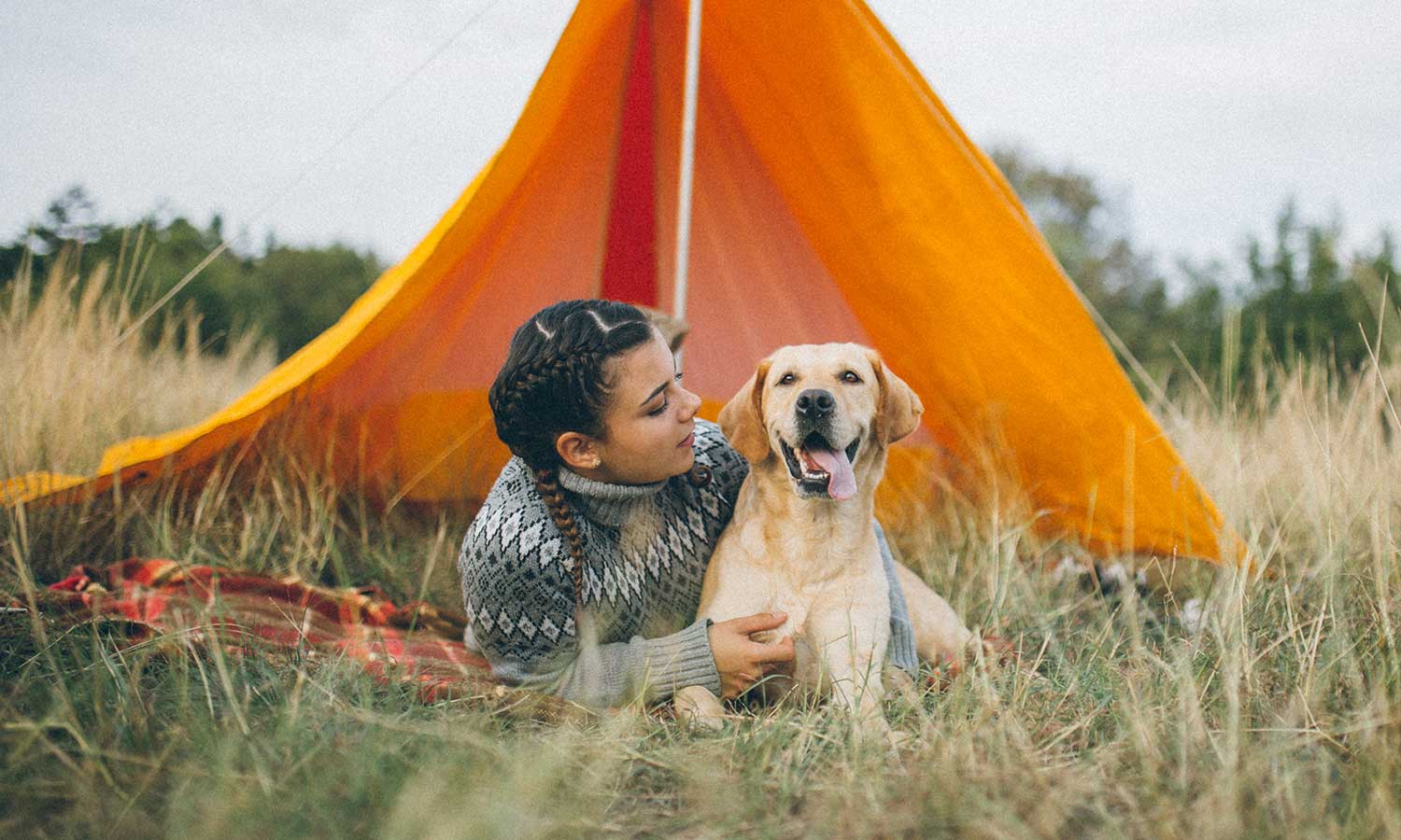 A woman with her dog outside